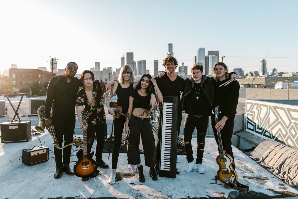A band standing together on a city rooftop