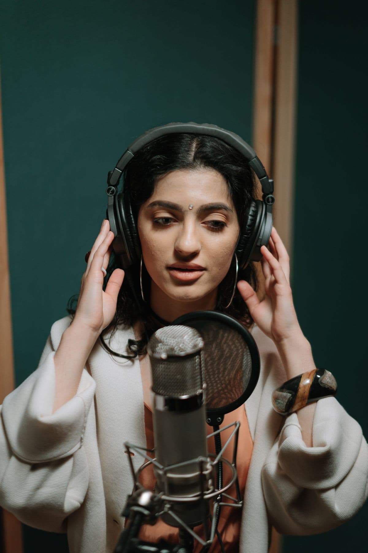A singer recording in a studio